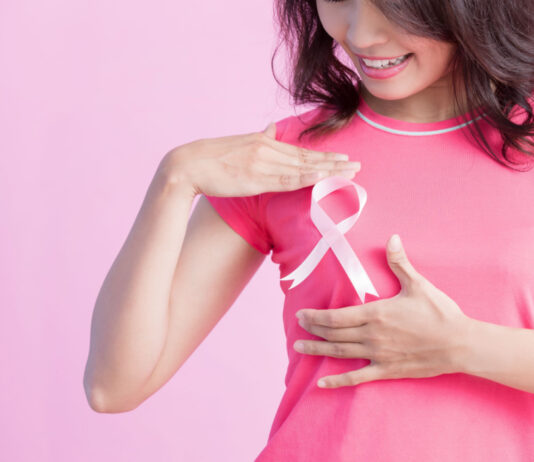 Cancer Survivor Says Cannabis Use “Was The Best Thing” woman with breast cancer ribbon 1 cancer survivor